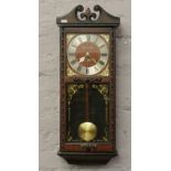 A president 31 day wall clock with scroll pediment and square dial.