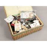 A basketware sewing box and contents of vintage buttons.