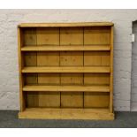 A pine open bookcase, height 110cm, width 106cm, depth 31cm.