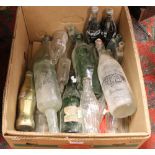 A box of glass advertising bottles to include Coca Cola etc.