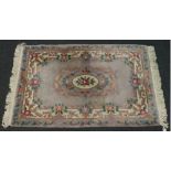 A violet ground Chinese Kayam wool rug with floral design. (206cm X 122cm)