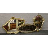 Three gilt framed wall mirrors to include an oval example.