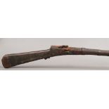 An antique eastern matchlock rifle, muzzle loading, possibly Afghan.