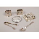 A tray of silver items including serviette rings, Bethlehem compact and sugar tongues etc.