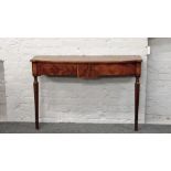 An Edwardian bow front frame mahogany console table raised on reeded legs.