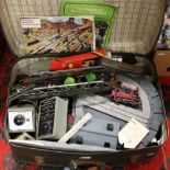 A vintage suitcase and contents of Hornby oo gauge railway to include track, transformers, buildings