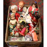A box of dolls dressed in clothes from around the world.