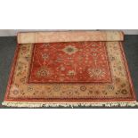 A red ground floral design Royal Keshan rug made in Belgium 3m x 2m.