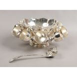 A silver plate punch set to include bowl, eight cups and serving ladle.