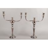 A pair of silver plate candelabras.