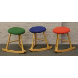 A set of beech three wave seat rocking stools.