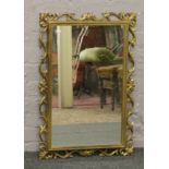 An ornate gilt framed mirror.