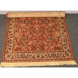 A burnt orange ground wool rug with floral decoration, 202cm x 139cm.