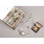 A tea caddy containing assorted collectables including coins, silver and jewellery etc.