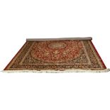 A red ground Keshan rug with medallion design, 2.8m x 2m.
