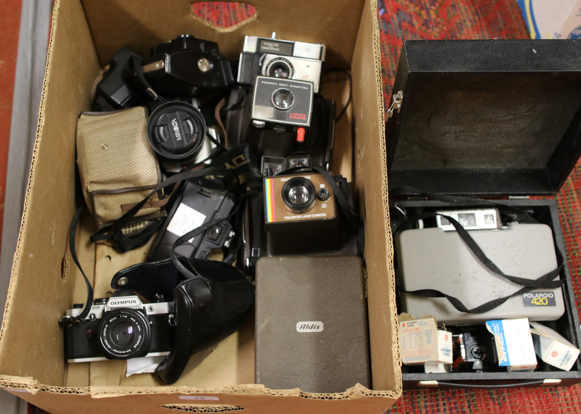 A box of cameras to include Olympus, Minolta, Polaroid, Kodak etc.