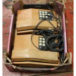 Two leather bound telecom trim telephones.