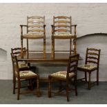 An oak refectory table and set of six ladder back chairs, to include two carvers.