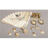 A silk and bone hand fan, painted with a bird along with a quantity of printed miniatures, some