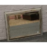 A silver and gilt framed bevel edge wall mirror, 74cm x 58cm.