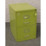 A vintage olive green steel two drawer filing cabinet, keys in office.