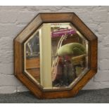 A carved oak hexagonal shaped bevel edge wall mirror.