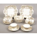 A 19th century Derby tea wares, decorated in gilt and grey to include bread and butter plates, cream