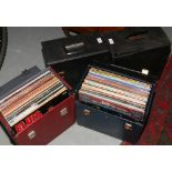 Four carry cases of L.P records to include Elvis, David Bowie, The Police, Elton John etc.