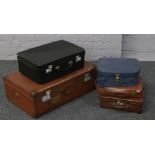 Five vintage travel cases of various sizes.