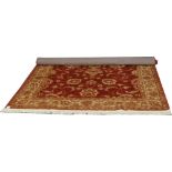 A red ground Ziegler rug with floral design 230cm x 160cm.