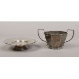An octagonal silver sugar pot with twin handles, assayed Birmingham 1928, along with a silver stand,