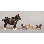 Four Beswick figurines one formed as a shire horse and the other formed as a foal.