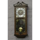 A President 31 day wall clock with scroll pediment and square dial.