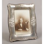 A white metal mounted eizel photograph frame.