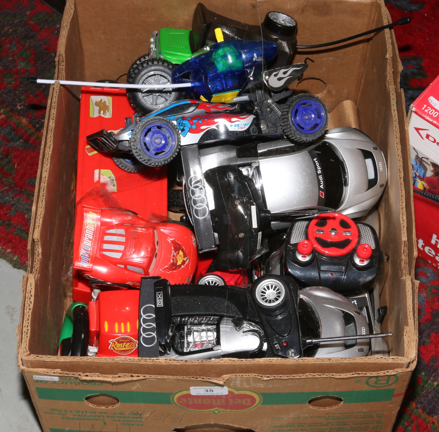 A box of remote control cars, all have remotes to match
