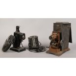 An early 20th century hand crank projector by J. Falk, along with a pathescope kid projector.