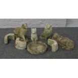 A collection of cast concrete garden ornaments formed as dogs and cats etc.