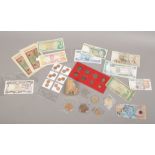 A collection of mainly foreign bank notes and coins to include a quantity of commemorative crowns.