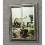 A silver and gilt framed bevel edge wall mirror, 74cm x 58cm.
