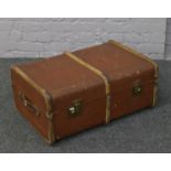 A vintage wood bound travel trunk.