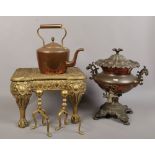 A brass coachman, copper plate samovar, pair of fire dogs and a copper and brass kettle.