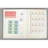 An album of British stamps including part sheets.