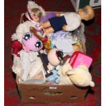 A box of dolls and soft toys.