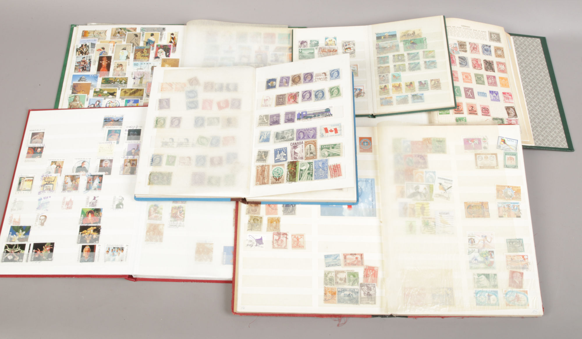 A collection of foreign stamps all in albums to include Japan, Chinese, Canada, Venezuela examples.