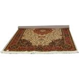 A beige ground Keshan rug with medallion design, 230cm x 160cm.