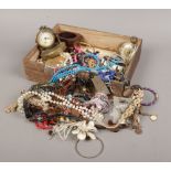 A box of costume jewellery to include Oris manual wristwatch, simulated pearls, brass desk clock