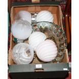 A box of glass light fittings and an art glass fruit bowl.