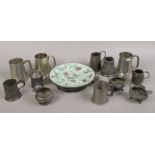 A pewter mounted Cantonese hot water plate, along with a collection of pewter tankards and jugs.