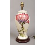 A Moorcroft table lamp base tube lined and decorated in the Magnolia design, standing 37cm tall.