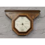 An Art Deco barometer with parquetry inlay decoration and octagonal shaped dial.